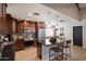 Well-lit kitchen featuring dark wood cabinetry, stainless steel appliances, and a large island with bar seating at 2619 E Jerome Ave, Mesa, AZ 85204