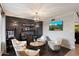 Stylish living room with dark accent wall, ambient lighting, and comfortable, neutral armchairs at 2619 E Jerome Ave, Mesa, AZ 85204