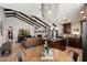 Open-concept living room and kitchen with vaulted ceilings and exposed beams, creating a spacious and inviting atmosphere at 2619 E Jerome Ave, Mesa, AZ 85204