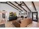 Inviting living room featuring beamed ceilings, a brick fireplace, and a comfortable leather sectional at 2619 E Jerome Ave, Mesa, AZ 85204