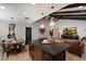 Open-concept space showcasing the kitchen island, a round dining table, and a cozy living area with a TV at 2619 E Jerome Ave, Mesa, AZ 85204