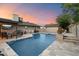 Backyard pool with stone trim, a hot tub, outdoor furniture, and a well-maintained patio area at 2619 E Jerome Ave, Mesa, AZ 85204