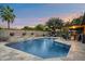 Beautiful backyard pool with a waterfall feature and a covered patio for outdoor relaxation at 2619 E Jerome Ave, Mesa, AZ 85204