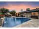 Enjoy a refreshing swim in this backyard pool with a cascading waterfall and beautifully landscaped surroundings at 2619 E Jerome Ave, Mesa, AZ 85204