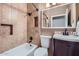 Bathroom with a bathtub, shower, tile walls, and a vanity with a modern faucet at 2801 N Litchfield Rd # 65, Goodyear, AZ 85395