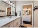 Bright bathroom featuring double sinks, modern fixtures, and a view into another bathroom at 2801 N Litchfield Rd # 65, Goodyear, AZ 85395