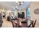 Dining area flowing into living room with ceiling fan and lots of natural light at 2801 N Litchfield Rd # 65, Goodyear, AZ 85395