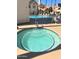 Close-up of a serene hot tub with tiled accents, adjacent to the community pool area at 2801 N Litchfield Rd # 65, Goodyear, AZ 85395