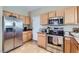 Bright kitchen with stainless steel appliances and a tile floor at 2801 N Litchfield Rd # 65, Goodyear, AZ 85395