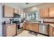 Well-lit kitchen with stainless steel appliances and ample counter space at 2801 N Litchfield Rd # 65, Goodyear, AZ 85395