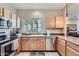 Cozy kitchen featuring stainless steel appliances, tile flooring, and natural light from the window at 2801 N Litchfield Rd # 65, Goodyear, AZ 85395
