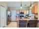 Open kitchen featuring stainless steel appliances, breakfast bar with wicker chairs, and neutral colors at 2801 N Litchfield Rd # 65, Goodyear, AZ 85395