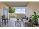 Relaxing covered patio with cushioned seating and a view of the manicured lawn at 2801 N Litchfield Rd # 65, Goodyear, AZ 85395