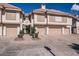 Attractive townhome featuring private garages and well-maintained landscaping at 2801 N Litchfield Rd # 65, Goodyear, AZ 85395