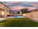 Wonderful backyard featuring a sparkling pool, sun loungers, and a well-maintained artificial grass area at 2986 E Country Shadows St, Gilbert, AZ 85298