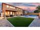 Relaxing backyard with a covered patio, a lush artificial grass, a sparkling pool, and lounge chairs at 2986 E Country Shadows St, Gilbert, AZ 85298