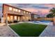 Beautiful backyard with a sparkling pool, covered patio, and lush artificial grass for low-maintenance living at 2986 E Country Shadows St, Gilbert, AZ 85298