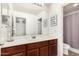 Bathroom featuring a large mirror, stylish fixtures, and a shower with glass doors for a spa-like experience at 2986 E Country Shadows St, Gilbert, AZ 85298