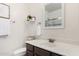 Clean bathroom features a vanity with a white sink, modern hardware, and a framed mirror at 2986 E Country Shadows St, Gilbert, AZ 85298