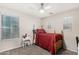 Comfortable bedroom with a full-sized bed, ceiling fan, and a small vanity for a relaxing space at 2986 E Country Shadows St, Gilbert, AZ 85298