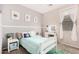 Charming bedroom with light blue bedding, soft pillows, and a vanity with a lighted mirror for a cozy retreat at 2986 E Country Shadows St, Gilbert, AZ 85298