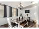 Cozy dining area showcasing a rustic wooden table, elegant chandelier, and stylish decor accents at 2986 E Country Shadows St, Gilbert, AZ 85298