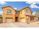 Attractive two-story home showcasing a stone facade, multiple garage doors, and a welcoming entrance at 2986 E Country Shadows St, Gilbert, AZ 85298