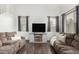 Spacious living room with hardwood floors, neutral color scheme, and comfortable seating at 2986 E Country Shadows St, Gilbert, AZ 85298