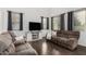 Comfortable living room with modern furniture, including plush sofas and a stylish entertainment center at 2986 E Country Shadows St, Gilbert, AZ 85298