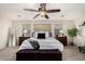 Bright main bedroom with a plush king-sized bed, stylish furniture, and ample natural light at 2986 E Country Shadows St, Gilbert, AZ 85298