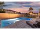 Private backyard pool with stone pavers and lounge chairs, perfect for relaxation and entertaining at 2986 E Country Shadows St, Gilbert, AZ 85298