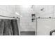 Modern bathroom showcasing white tile walls, black herringbone floor, and built-in shelving for toiletries at 3103 S Benton --, Mesa, AZ 85212