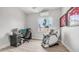 Bright bedroom features a massage chair, sports memorabilia, wood-look floors, and a ceiling fan at 3103 S Benton --, Mesa, AZ 85212