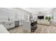 Open concept kitchen and living room featuring white cabinets, stainless appliances, marble counters, and island at 3103 S Benton --, Mesa, AZ 85212