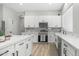 Bright kitchen features white cabinetry, stainless appliances, marble counters, and a center island at 3103 S Benton --, Mesa, AZ 85212