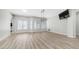 Spacious living room with wood-look floors, large windows, and modern lighting fixture at 3103 S Benton --, Mesa, AZ 85212