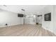 Open-concept living room with wood-look flooring and modern lighting fixtures at 3103 S Benton --, Mesa, AZ 85212