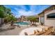 Backyard pool with blue skies and decorative stones in a desert landscaped setting with lush palms at 3103 S Benton --, Mesa, AZ 85212