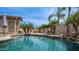 Relaxing pool with landscaped rocks and palm trees in the backyard, perfect for enjoying sunny days at 3103 S Benton --, Mesa, AZ 85212