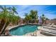 Sparkling backyard pool with rock waterfall feature and lounge chairs at 3103 S Benton --, Mesa, AZ 85212