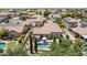 Aerial view showcases this desert home's private pool, lush backyard, and stucco exterior at 3441 S Halsted Pl, Chandler, AZ 85286
