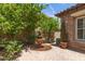 Private backyard features a decorative fountain, lush greenery, and a peaceful outdoor retreat at 3441 S Halsted Pl, Chandler, AZ 85286