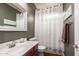 Cozy bathroom featuring a single sink vanity, a toilet, and a shower with a white curtain at 3441 S Halsted Pl, Chandler, AZ 85286