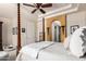 Spacious bedroom featuring a four-poster bed, unique architectural archway, and ceiling fan at 3441 S Halsted Pl, Chandler, AZ 85286