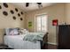Bright bedroom with playful decor, featuring a bed with a patterned quilt and a black dresser at 3441 S Halsted Pl, Chandler, AZ 85286