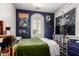 Dark blue bedroom featuring a bed with a green comforter and assorted wall art at 3441 S Halsted Pl, Chandler, AZ 85286