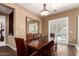 Elegant dining room with a large table, bench seating, a large mirror, and window views of the pool at 3441 S Halsted Pl, Chandler, AZ 85286