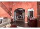 Grand foyer featuring a staircase, brick archway, and comfortable seating area at 3441 S Halsted Pl, Chandler, AZ 85286