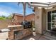 Outdoor grill area with a stone grill and dining area in the backyard at 3441 S Halsted Pl, Chandler, AZ 85286