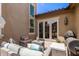Inviting outdoor patio featuring comfortable seating, a grill, and sliding glass doors at 3441 S Halsted Pl, Chandler, AZ 85286